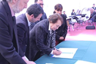 La decana de la Facultad de Artes, prof. Clara Luz Cárdenas, firmando el convenio que permitirá potenciar las artes en los colegios municipales de Isla de Maipo.