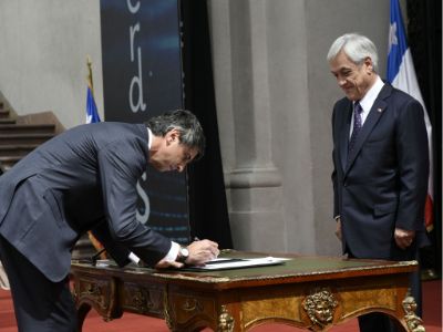 El doctor Couve en la firma de aceptación como el primer ministro de Ciencia y Tecnología del país, frente al Presidente Sebastián Piñera