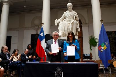 El rector Ennio Vivaldi y la la coordinadora del área de gobernabilidad en la oficina de Chile del PNUD, Marcela Ríos, en la firma de convenio de trabajo colaborativo entre ambas instituciones.